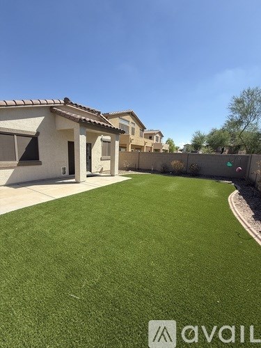A house with a green lawn in front of it.