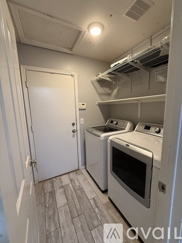 A small laundry room with a washer and dryer.