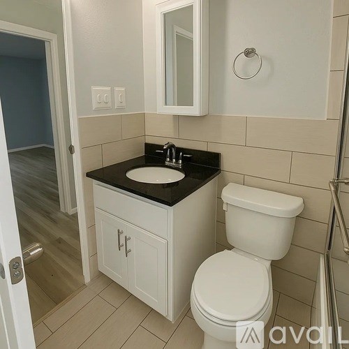 A white toilet sits next to a sink in a bathroom.