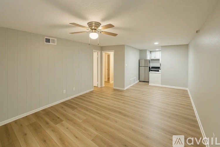 A room with wooden flooring and a ceiling fan.