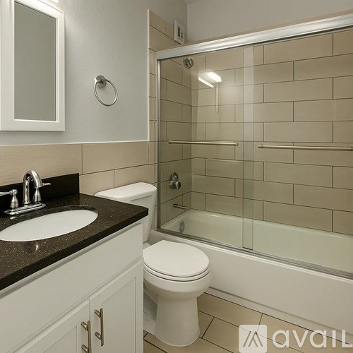 A bathroom with a toilet, sink, and tub.
