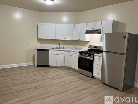 A kitchen with white cabinets and stainless steel appliances.