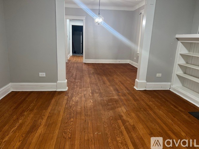 A red brick house with a black fence and a white door.