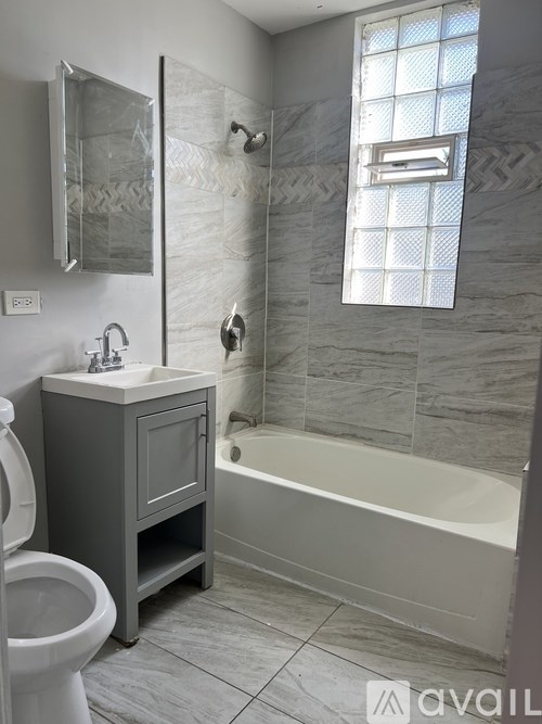 A bathroom with a toilet, sink, and bathtub.