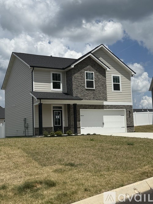 A two-story house with a garage is available for sale.