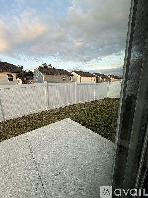 A white fence in front of a row of houses.
