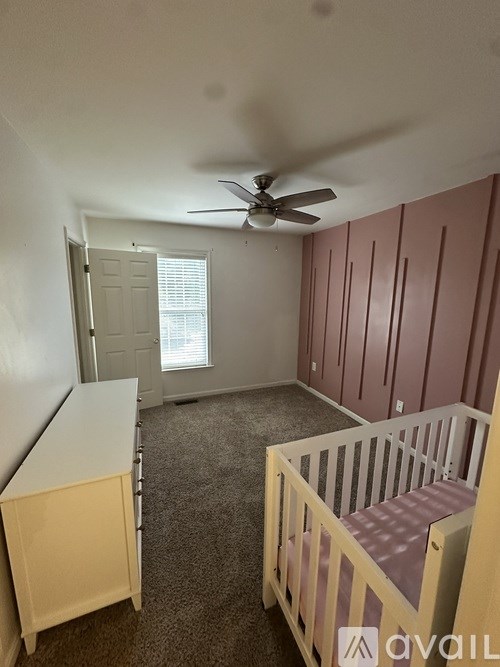 A baby room with a crib and a dresser.