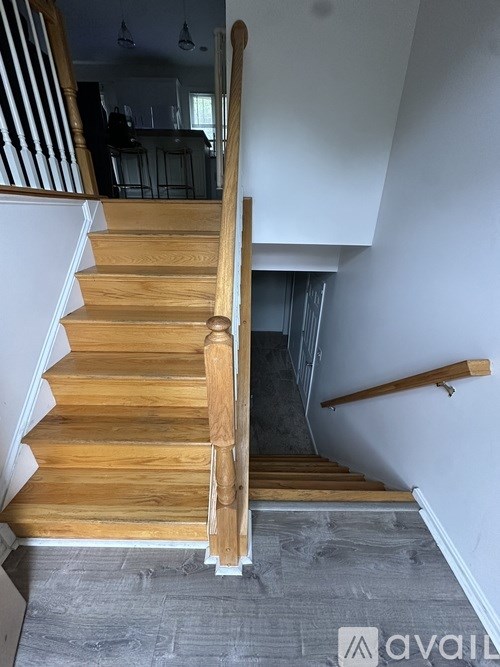 A wooden staircase with a carpeted floor.