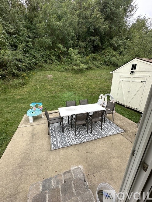 A patio with a table and chairs is shown.