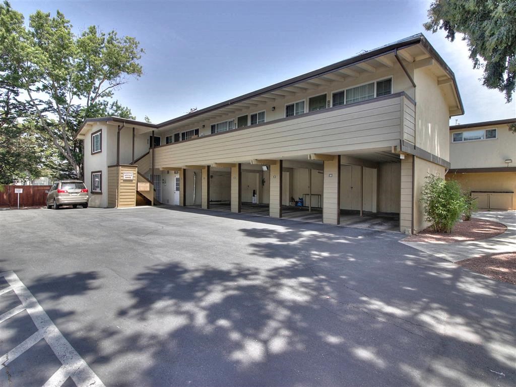 a building with a parking lot and a car in front of it