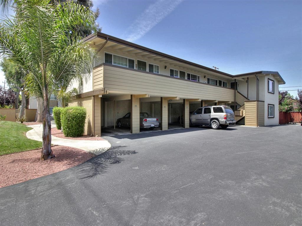 a building with a parking lot and cars in front of it