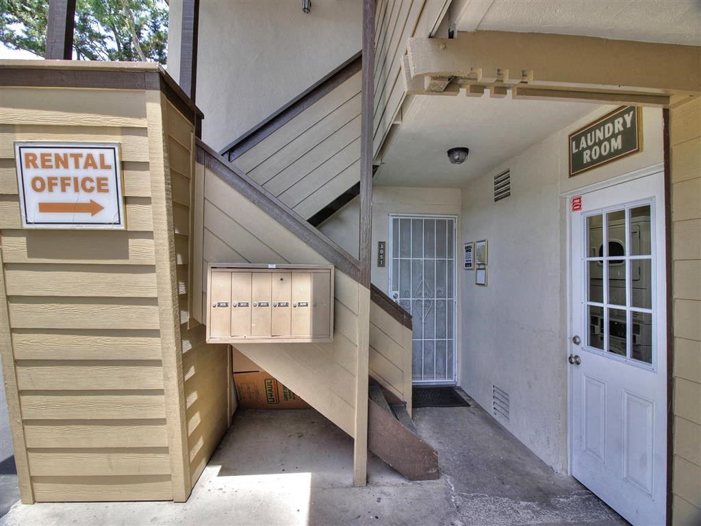 the entrance to a rental office with a white door