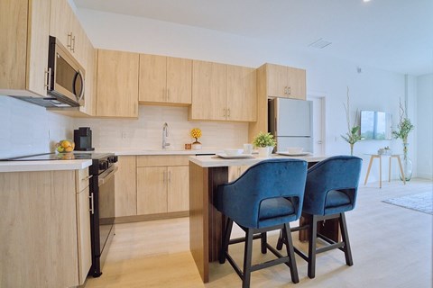 A kitchen with wooden cabinets and a white countertop.