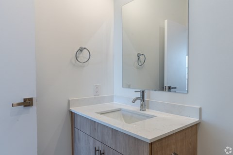 A bathroom with a sink and a mirror.