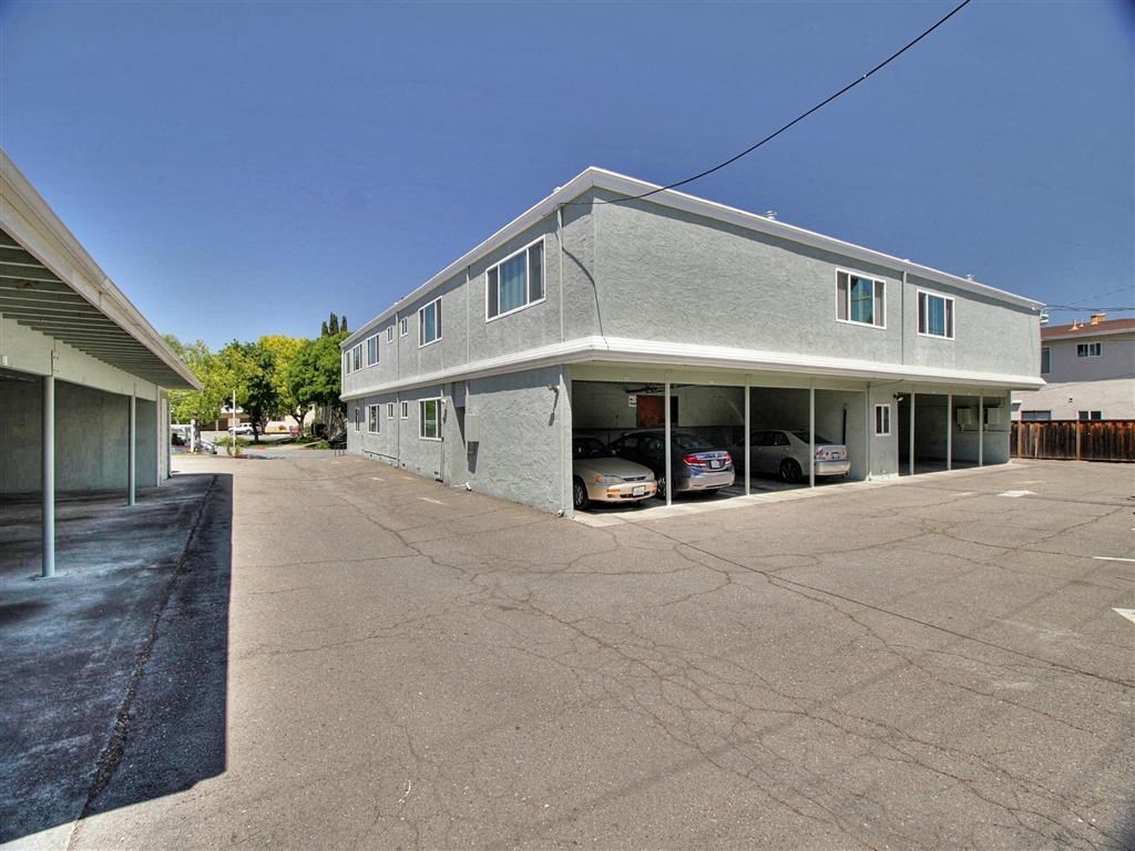 A parking lot with a building in the background.