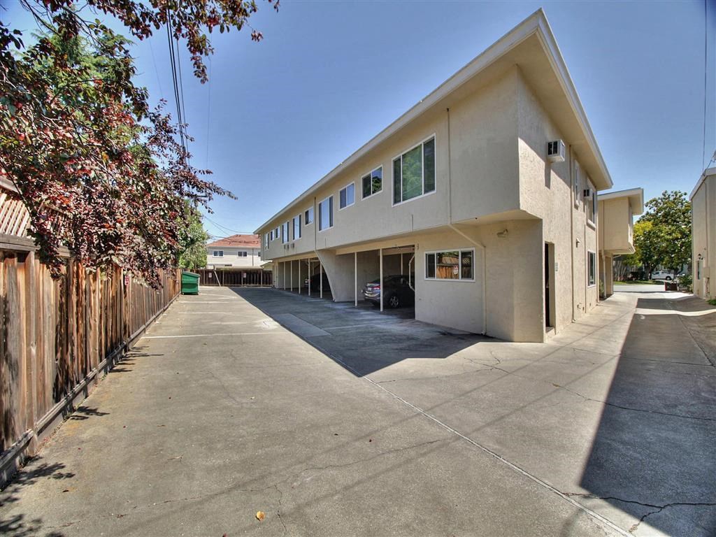 A long concrete parking lot in front of a building.