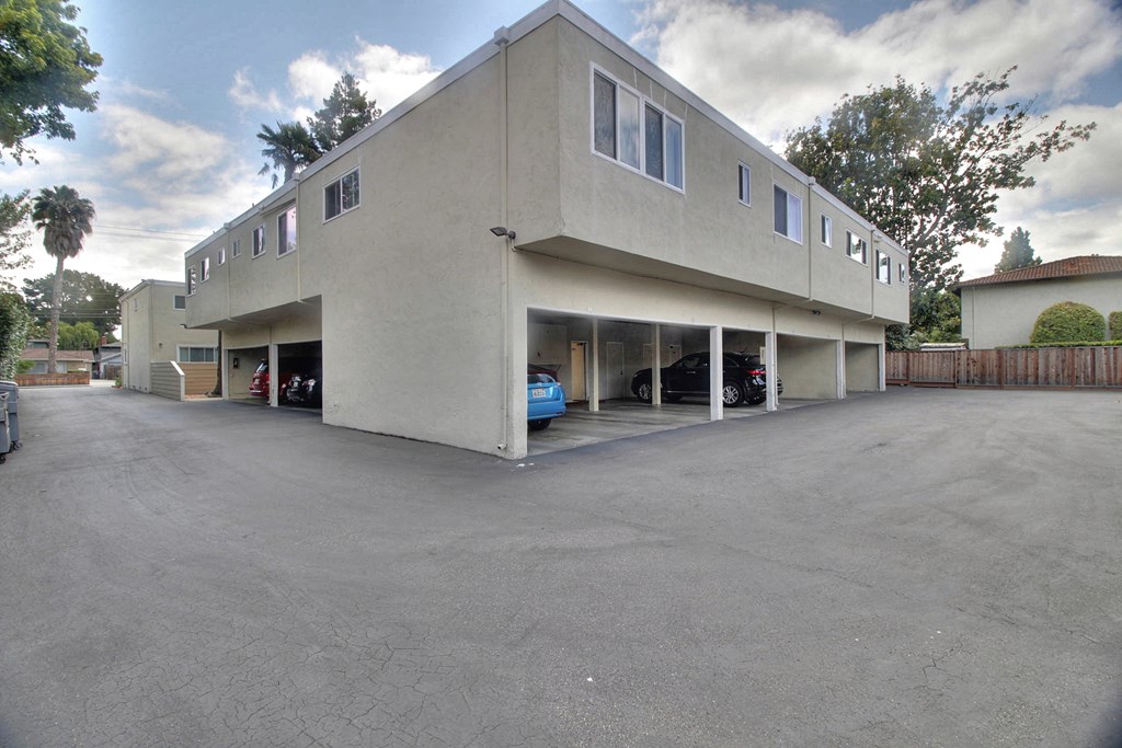 A large building with a parking lot in front.