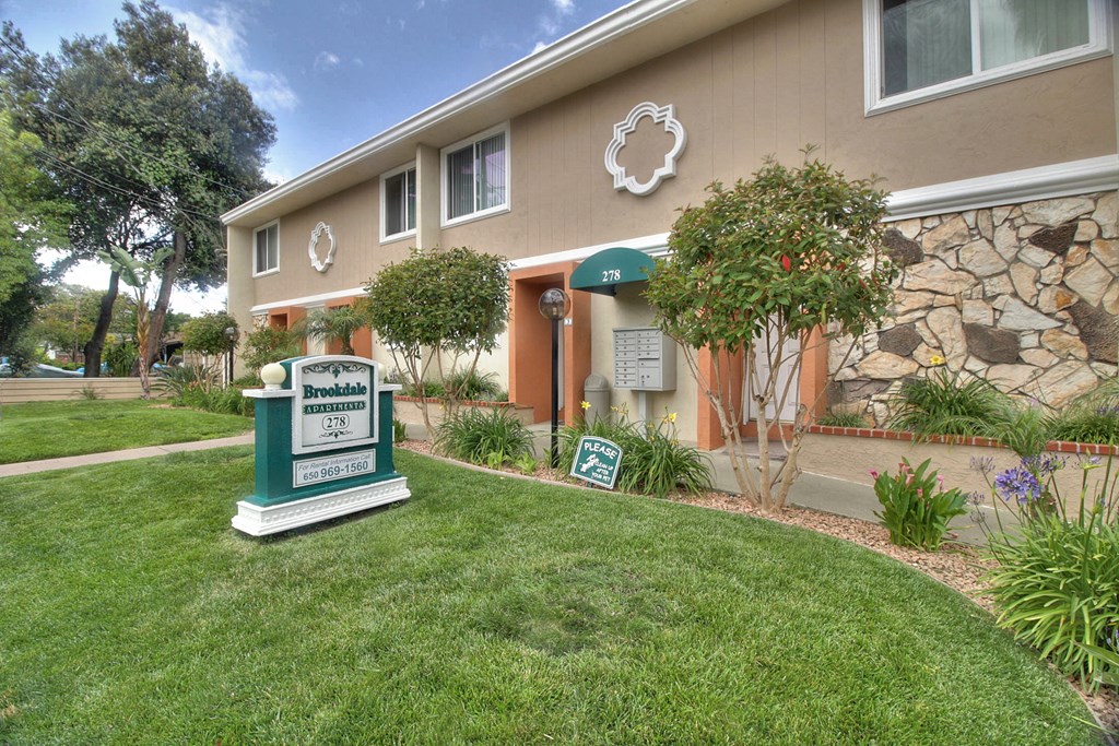 A building with a sign that says Brooksdale Estates in front of it.