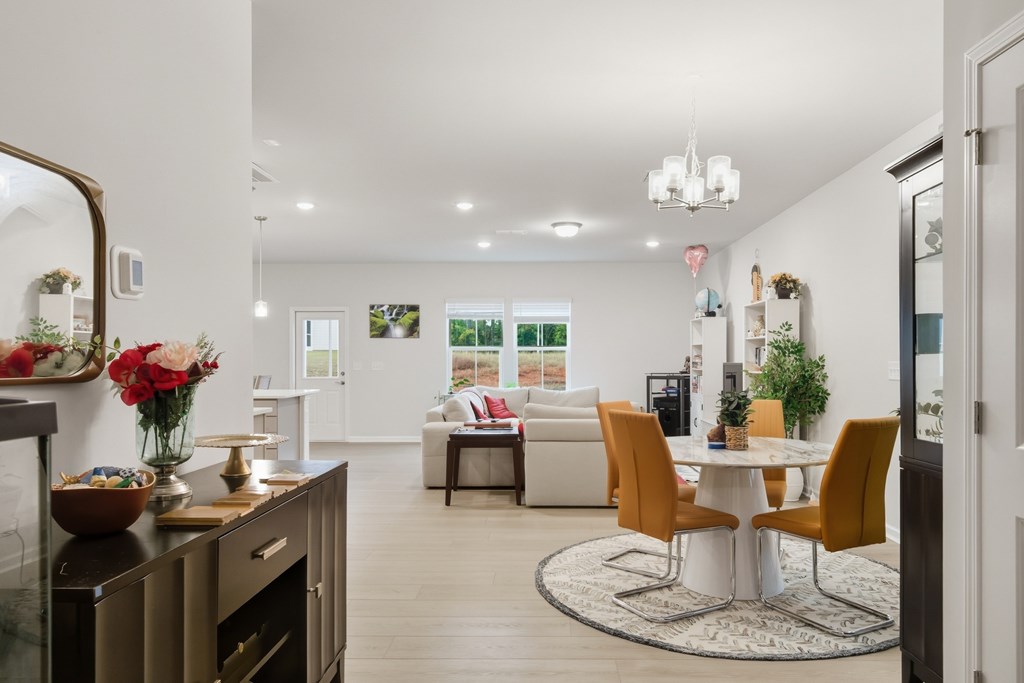 A modern kitchen with a dining table and chairs.