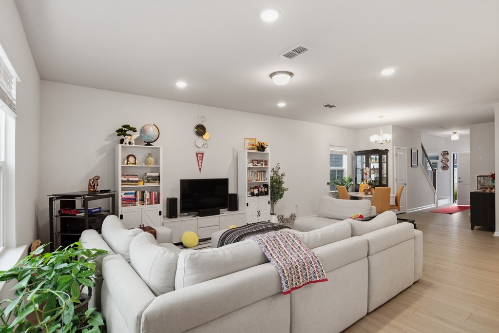 A living room with a white couch and a television.