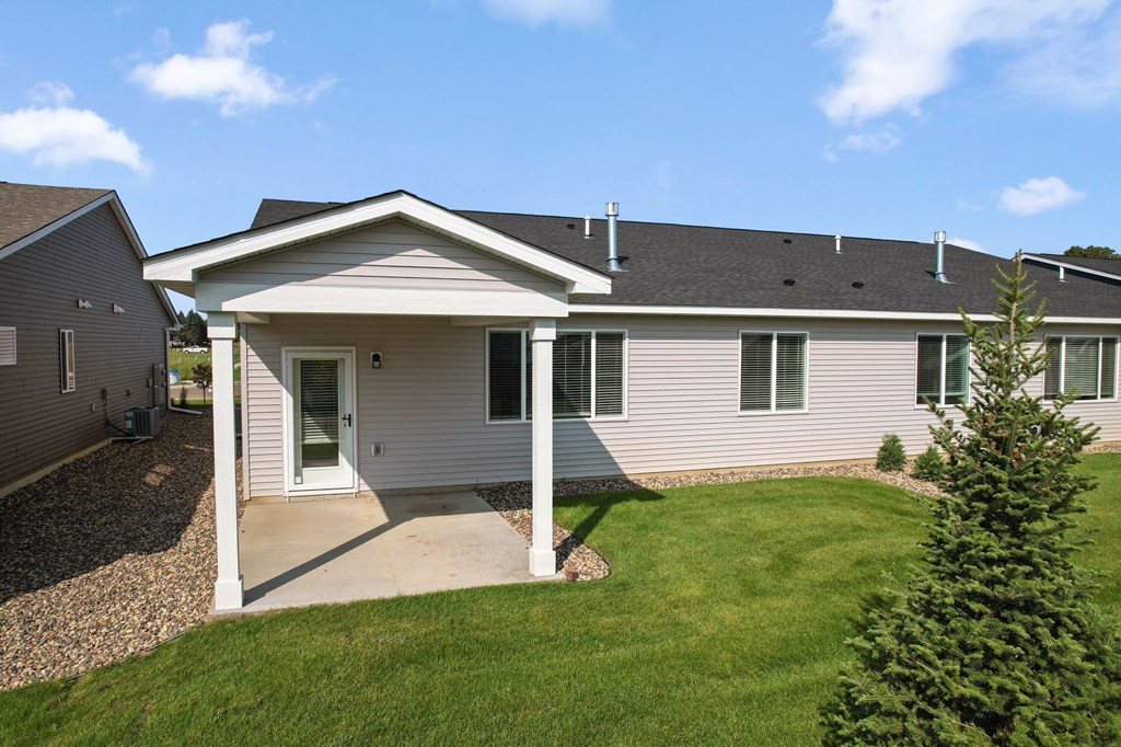 A house with a grey roof and a white porch.