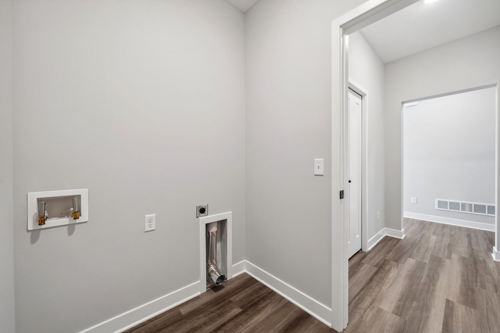 A room with a white wall and a white door.