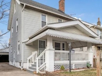 A two-story house with a white front porch.