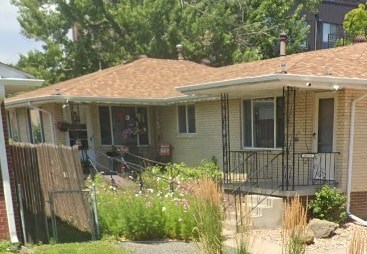 A house with a brown roof and a balcony.