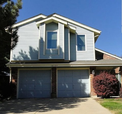 A two-story house with a garage.