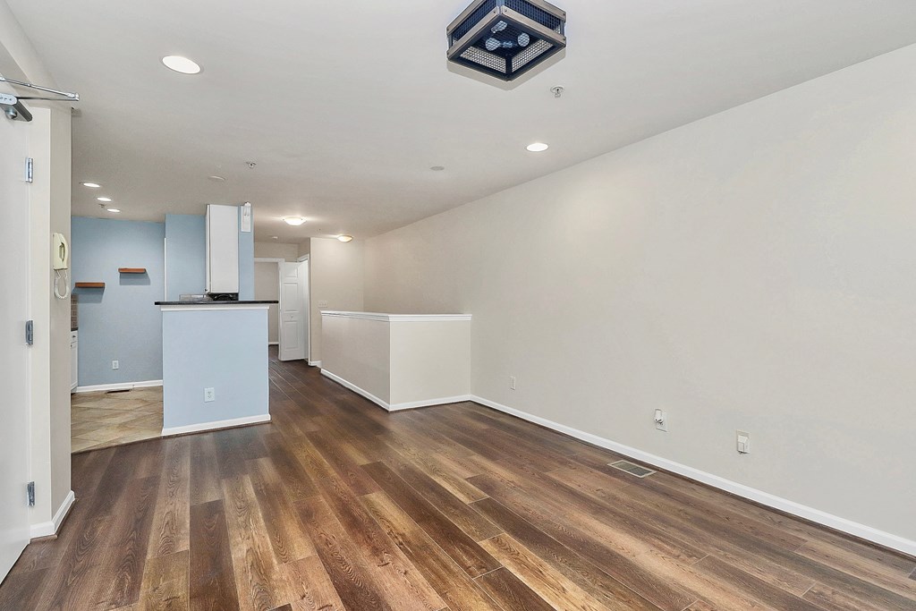 A room with wooden floors and white walls.
