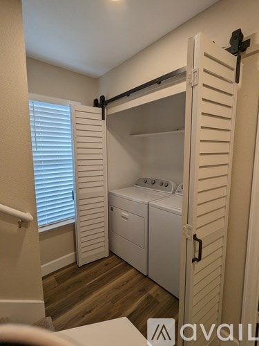 A small white laundry room with a washer and dryer.