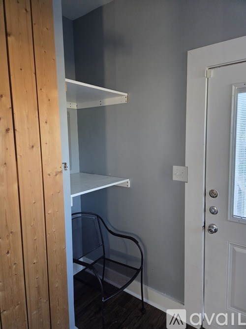 A bedroom with a bed, a ceiling fan, and a window with curtains.