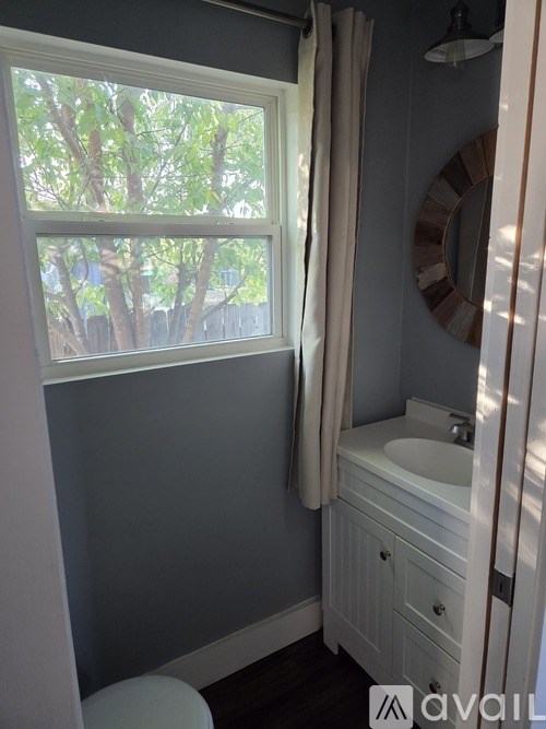 A room with a wooden ceiling and a desk with a monitor on it.