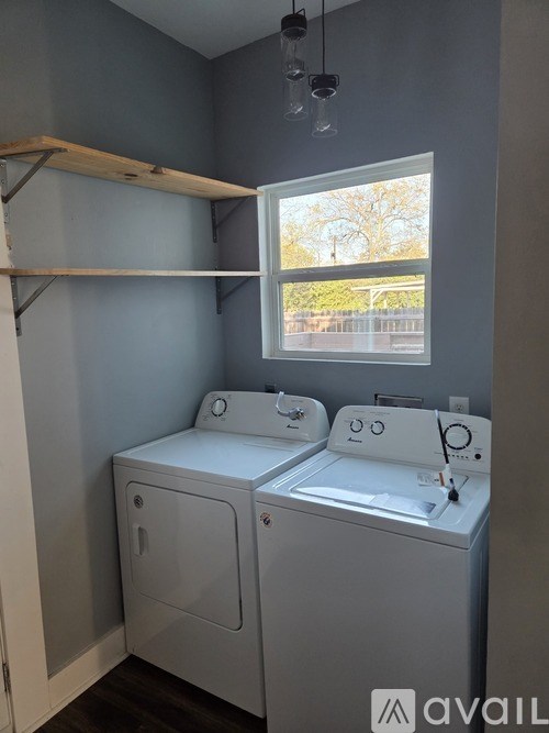 A bathroom with a toilet, sink, and mirror.
