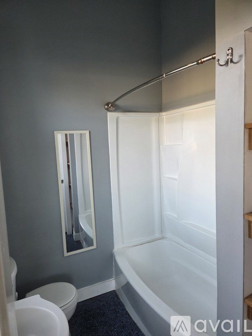 A room with boxes and a doorway leading to another room.