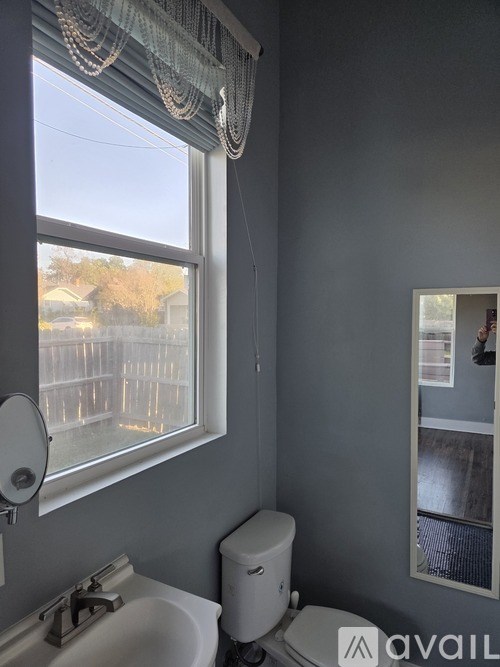 A room with a white door and a white cabinet with a red basket on top.
