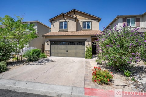 A house with a garage and a driveway in front of it.