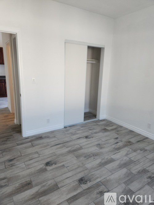 A room with a grey floor and white walls.