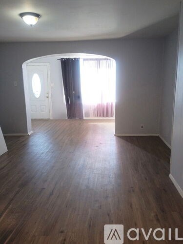 A room with wooden floors and a white door.