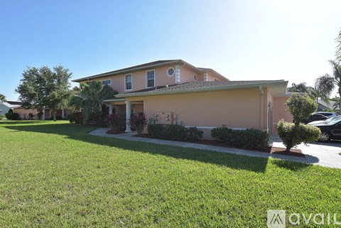 A house with a well-maintained lawn in front.