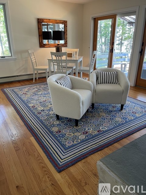 A living room with two chairs and a table.