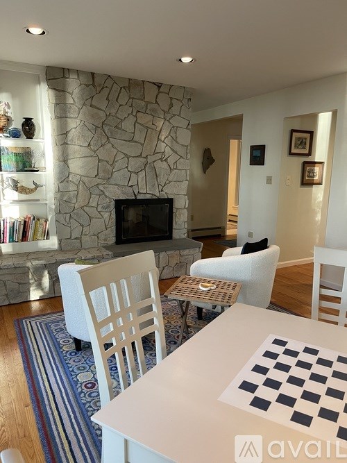 A living room with a stone wall and a television.