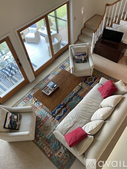 A living room with a couch, chair, and a coffee table.