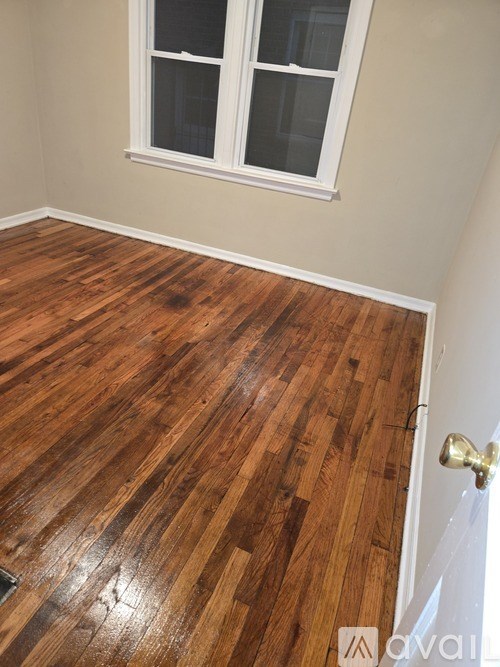 A room with a wooden floor and a white door.