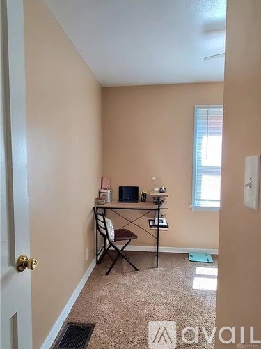 A room with a desk and a chair.