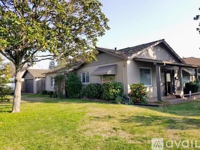 A house with a tree in front of it.