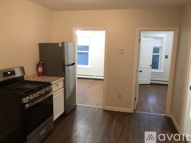 A kitchen with a black stove top oven and a black refrigerator.