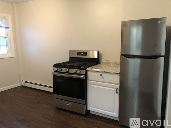 A kitchen with a stainless steel refrigerator, oven, and range.