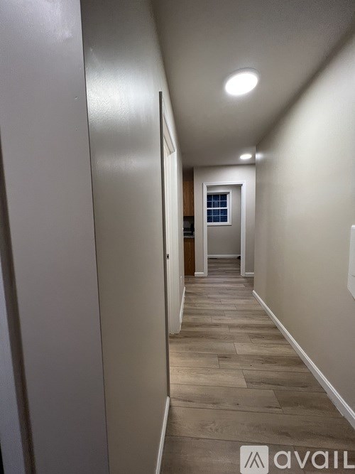 A long hallway with a door at the end.