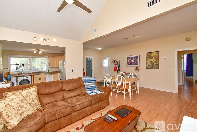 A living room with a brown couch and a wooden coffee table.